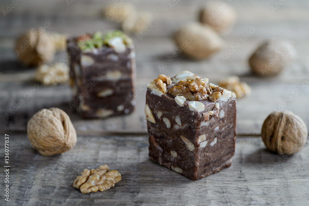 walnuts and nut halva on a rustic wooden surface. walnuts and nut halva on a rustic wooden surface.