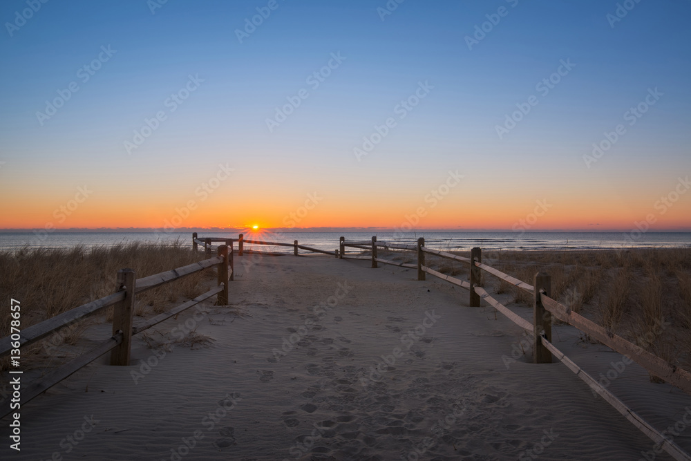 Jersey shore sunrise along a path leading to the ocean