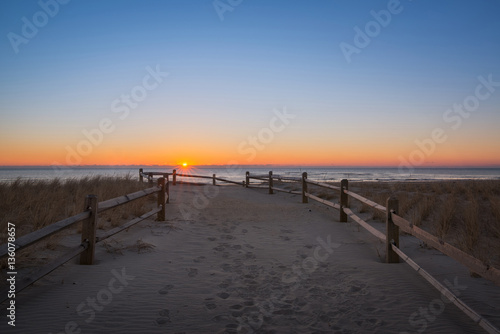 Jersey shore sunrise along a path leading to the ocean © Michael