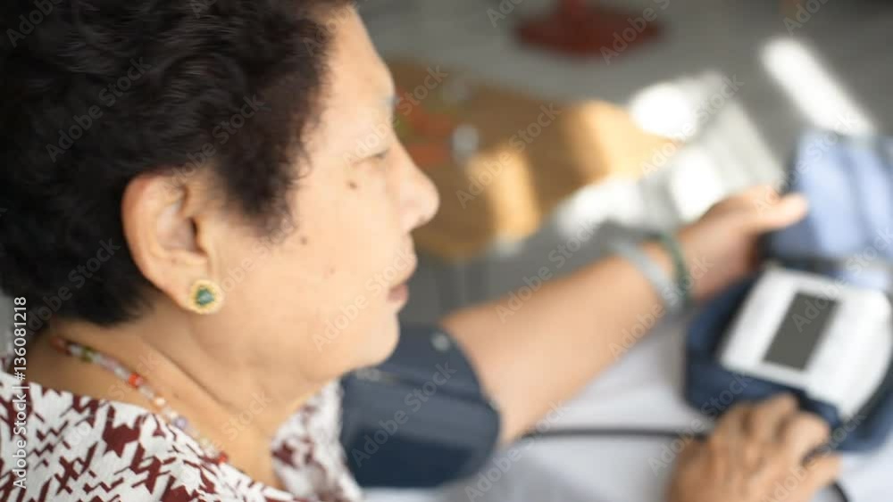 Asian senior woman checking blood pressure Asian senior woman checking blood pressure