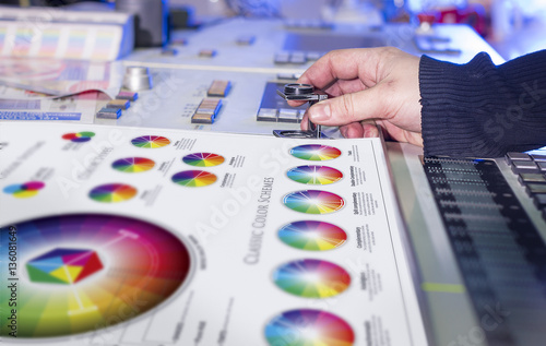 Young man in the process of offset printing and color correction