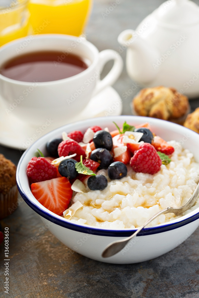 Rice pudding with fresh berries and coconut for breakfast Rice pudding with fresh berries and coconut for breakfast