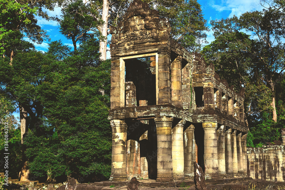 Naklejka premium Tower, huge trees and galleries in Preah Khan Temple