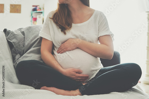 Pregnant woman touching her belly