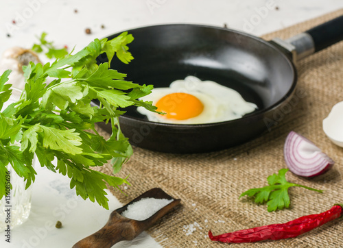 Morning in the kitchen. Cooking breakfast. Fried egg.