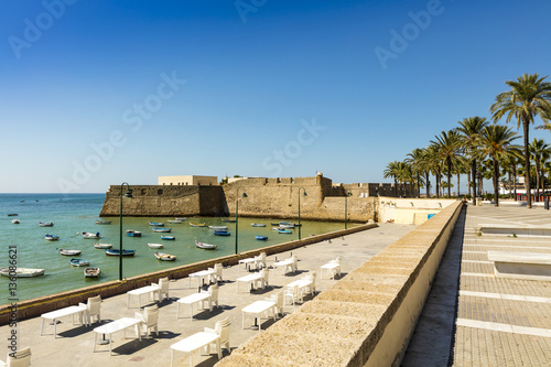 Seafront with view of medieval Castle of Santa Catalina, Cadiz (Spain).
