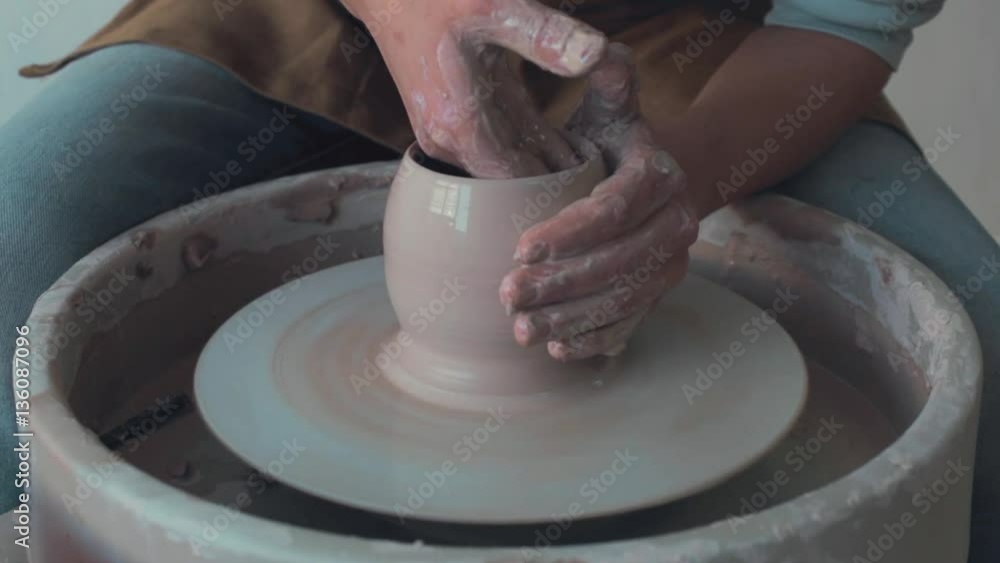 Potter Works On His Craft On A Spinning Pottery Wheel Potter Works On His Craft On A Spinning Pottery Wheel