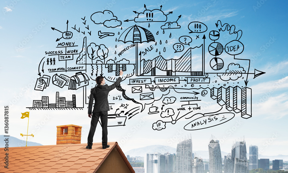 Rear view of businessman on house roof drawing his new business strategy. Mixed media Rear view of businessman on house roof drawing his new business strategy. Mixed media
