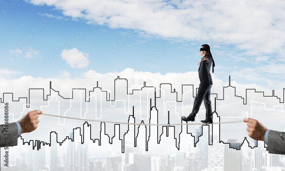 Business concept of risk support and assistance with man balancing on rope Business concept of risk support and assistance with man balancing on rope