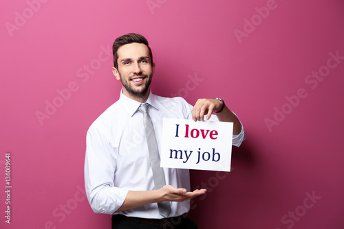 Man holding paper with text...