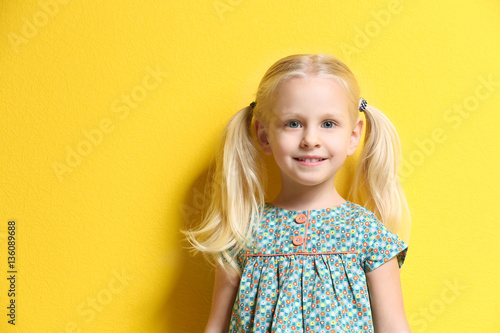 Cute little girl on color b...