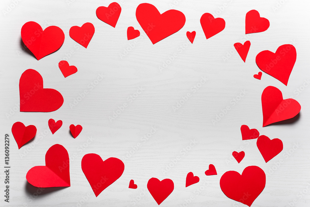 Wooden white background with red hearts. The concept of Valentin