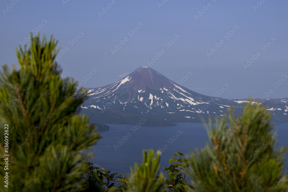 Fototapeta premium Picturesque summer volcanic landscape of Kamchatka Peninsula: view of active Ilyinsky Volcano (Ilyinskaya Sopka). Eurasia, Russia, Far East, Kurile lake, South Kamchatka Sanctuary