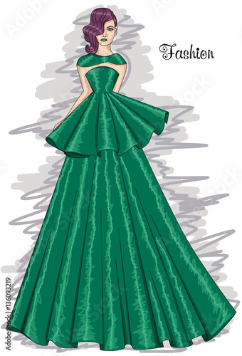 Woman in a long green dress. Lush meadow-colored dress. Hairstyle and Fashion.