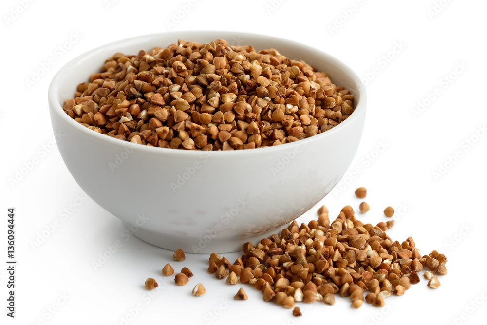 Dry buckwheat in white ceramic bowl isolated on white. Dry buckwheat in white ceramic bowl isolated on white.
