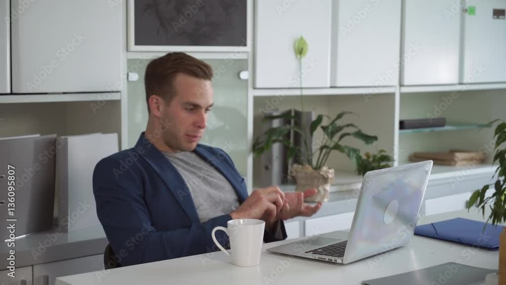 Man has video call meeting with client in the office. Use internet and app for calling. Man has video call meeting with client in the office. Use internet and app for calling.