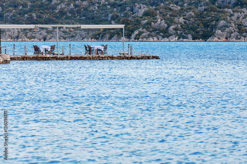 Restaurant tables on a jetty in the harbor. Uçagiz-Turkey. 0789