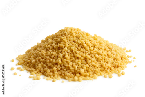 Heap of dry couscous isolated on white. photo