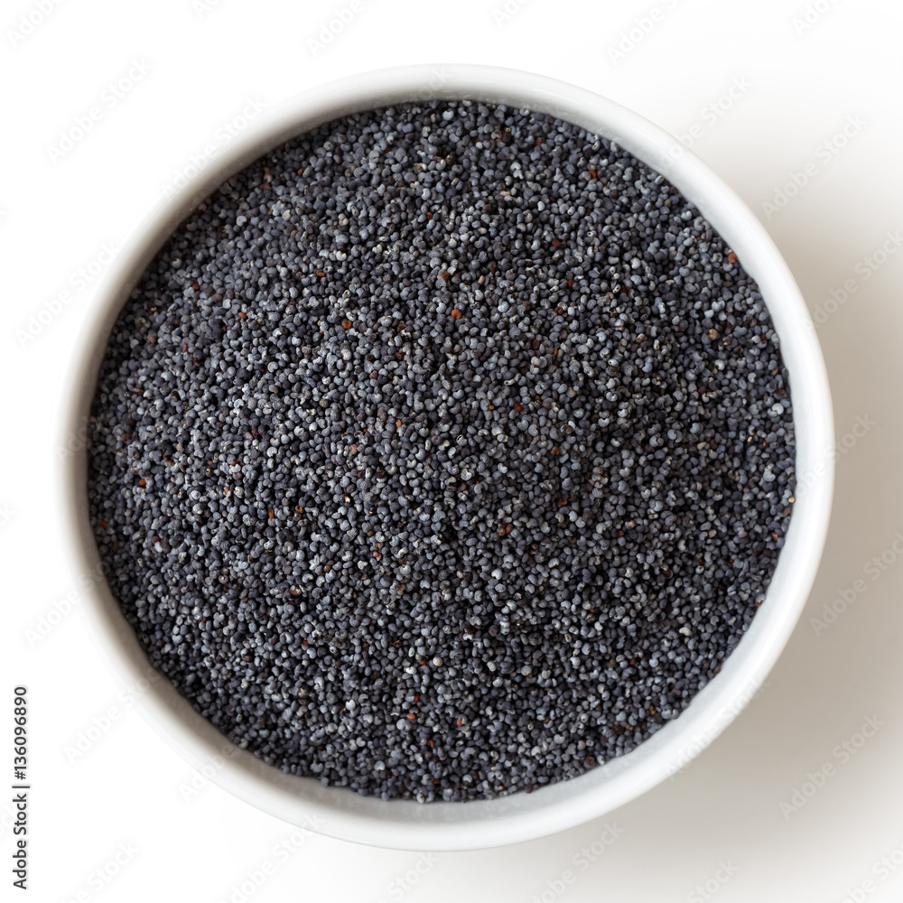 Dry poppy seeds in white ceramic bowl isolated on white. Dry poppy seeds in white ceramic bowl isolated on white.