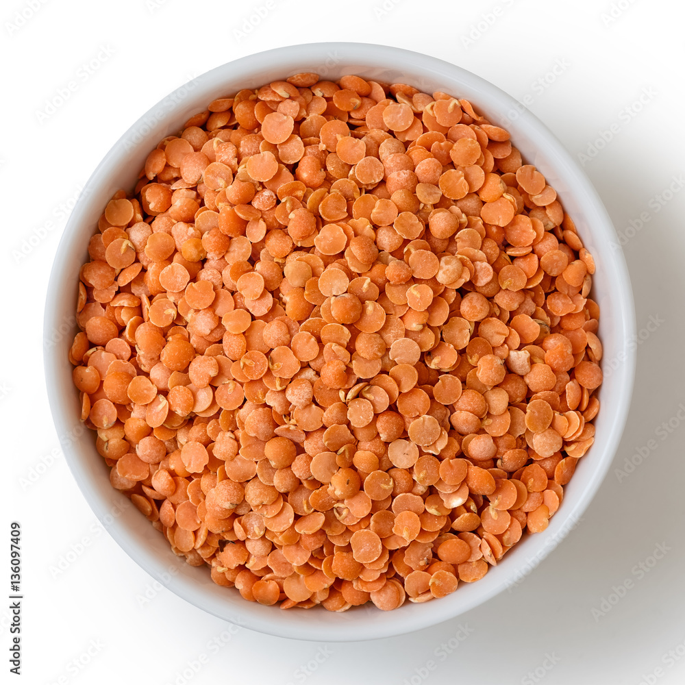 Dry red lentils in white ceramic bowl isolated on white. Dry red lentils in white ceramic bowl isolated on white.