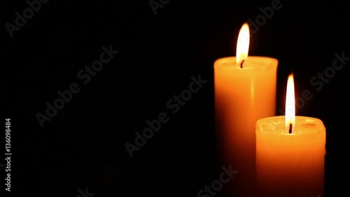 Two candles lit blur focus. Bright light on dark background. RIP darkness template. Birthday party. Romantic evening on Valentine.