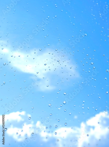 The sky through the drops on the window. This photo clear sky after the rain, giving us light mood.
