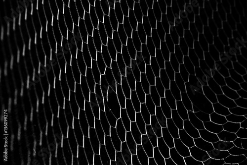 soccer ball in goal net isolated on black background
