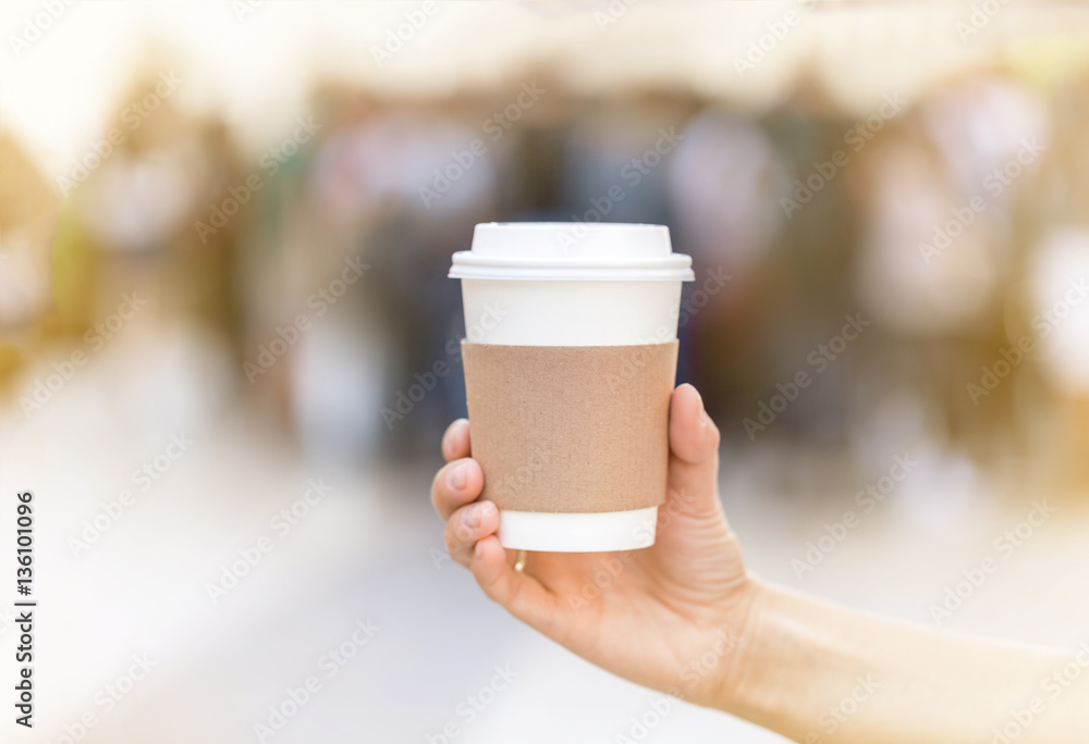 Paper cup of takeaway coffee in the hand. Place for your text or logo Paper cup of takeaway coffee in the hand. Place for your text or logo