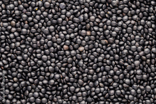 Food and cookery background of healthy dried  black lentils.
