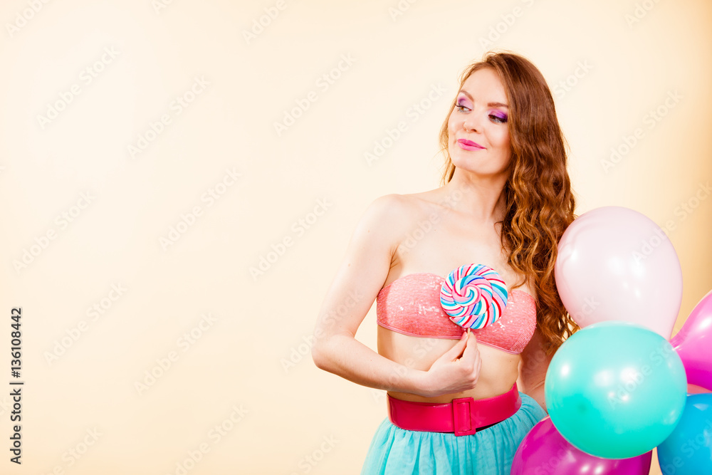 Woman holds lollipop candy and balloons Woman holds lollipop candy and balloons