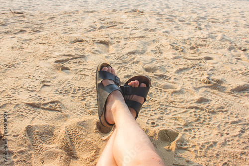 Feet of a man relaxing on the sand