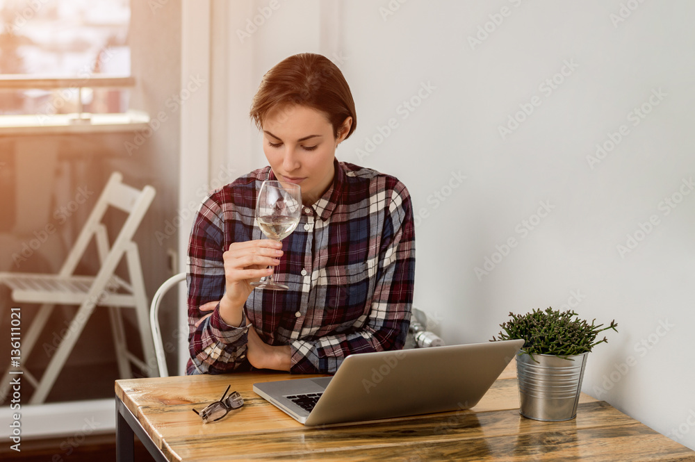 Portrait of a serious businesswoman using laptop in office. Lens Portrait of a serious businesswoman using laptop in office. Lens