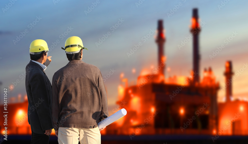 engineering man standing against oil refinery plant in heavy petrochemical industrial estate , industry 4.0 concept engineering man standing against oil refinery plant in heavy petrochemical industrial estate , industry 4.0 concept
