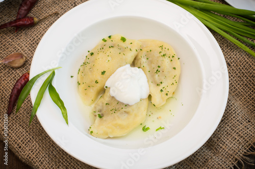 Dumplings with meat and greens. Wooden background. Top view. Close-up
