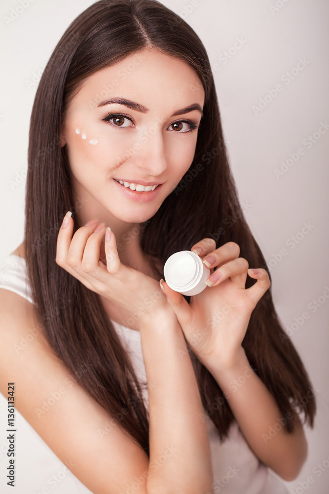 Skin Care. Beautiful healthy young woman with long hair, caring for their skin. Use cream for body care. Beauty and health Skin Care. Beautiful healthy young woman with long hair, caring for their skin. Use cream for body care. Beauty and health