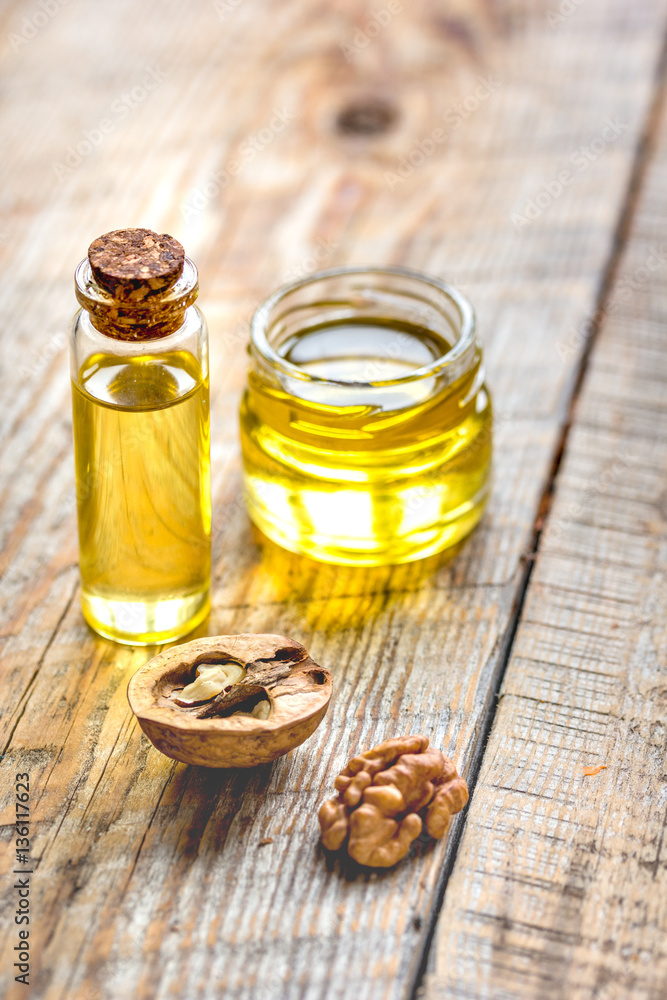 cosmetic and therapeutic walnut oil on wooden background cosmetic and therapeutic walnut oil on wooden background