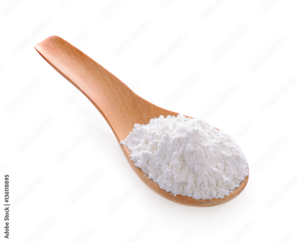 Pile of white wheat flour in wooden spoon Pile of white wheat flour in wooden spoon
