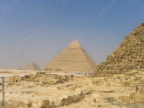 Many tour buses and people by great pyramids in Giza