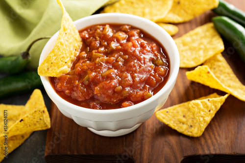 Red tomato spicy salsa with chips
