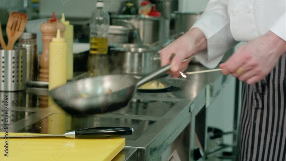 Chef cooking vegetables with flame