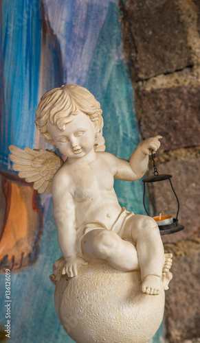 statue of angel holding a lantern