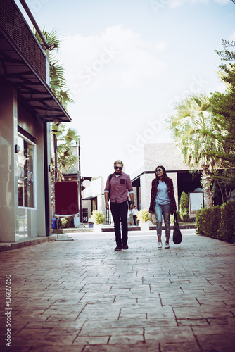 Portrait of hipster couple walking in the street urban.