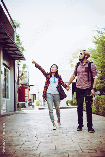 Portrait of hipster couple walking in the street urban.
