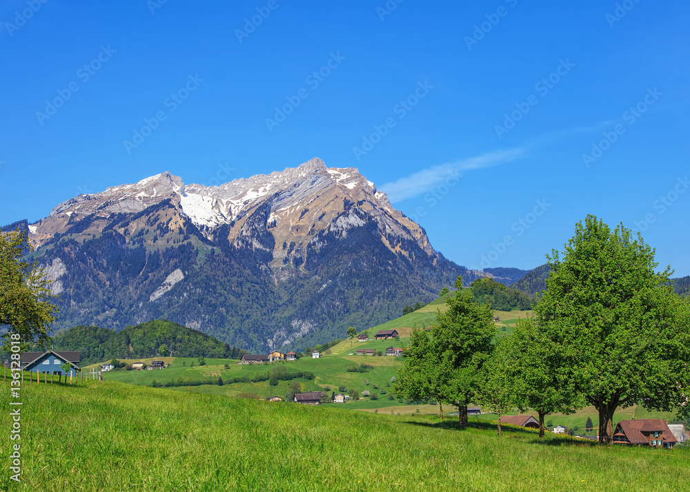 Springtime view from the foot of Mt. Stanserhorn in the Swiss canton of Nidwalden, Mt. Pilatus in the background Springtime view from the foot of Mt. Stanserhorn in the Swiss canton of Nidwalden, Mt. Pilatus in the background