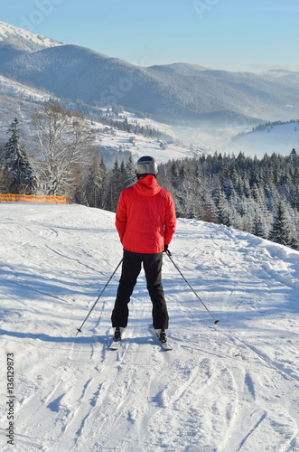 skier male on snowy mountain man full length back view portrait with copy space