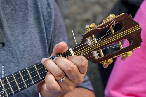 Small guitar with four strings called cavaquinho in Brazil and traditionally used in the styles of samba and chorinho photo