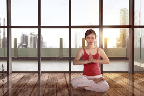 Beautiful asian female doing meditation in yoga pose