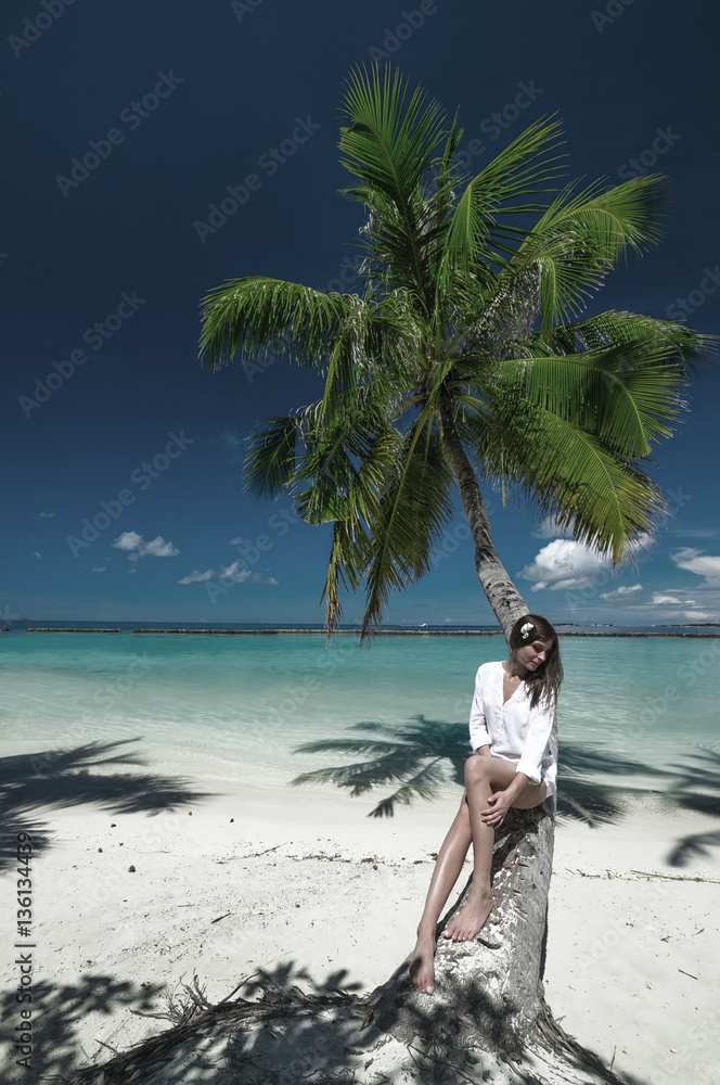Dreaming girl at white sand beach on tropical island