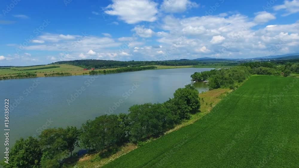 Aerial View. Flying over the beautiful lake near mountains. Aerial camera shot. Landscape panorama Aerial View. Flying over the beautiful lake near mountains. Aerial camera shot. Landscape panorama