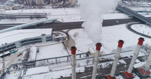 Pipes of thermal power plant and smoke. Air pollution. Aerial view. photo